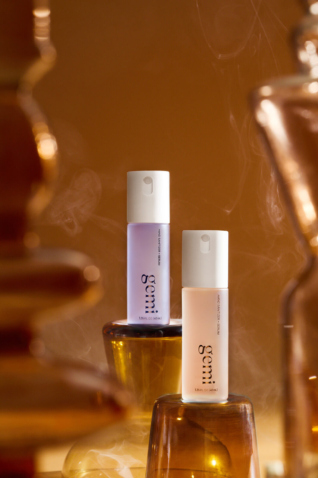 Two hand sanitizer bottles labeled 'gemi' on a decorative background.