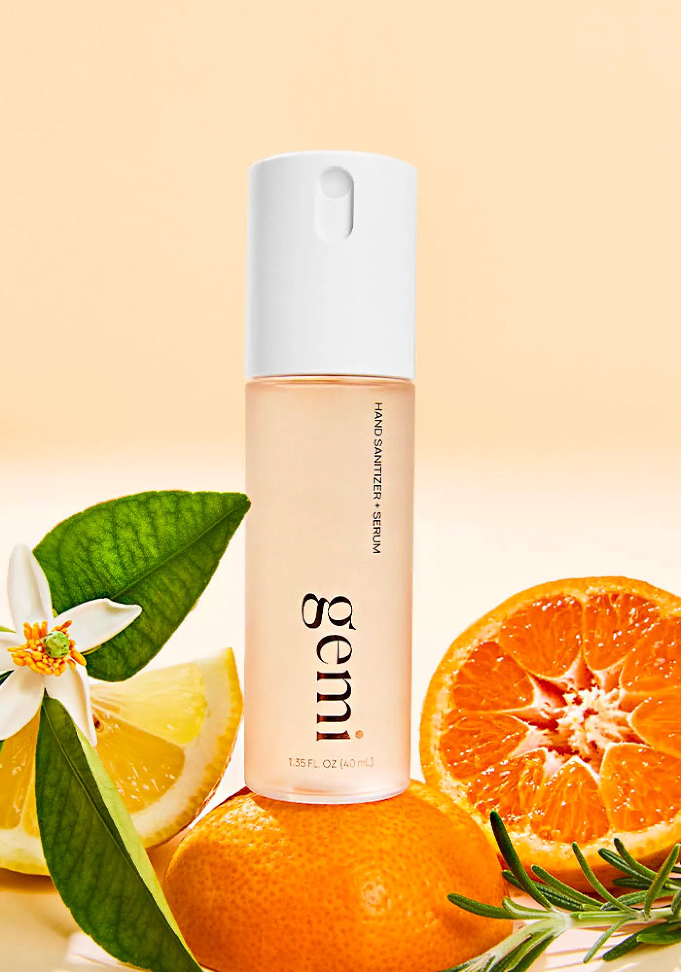 Hand sanitizer bottle labeled 'gemi' with oranges and rosemary on a beige background.