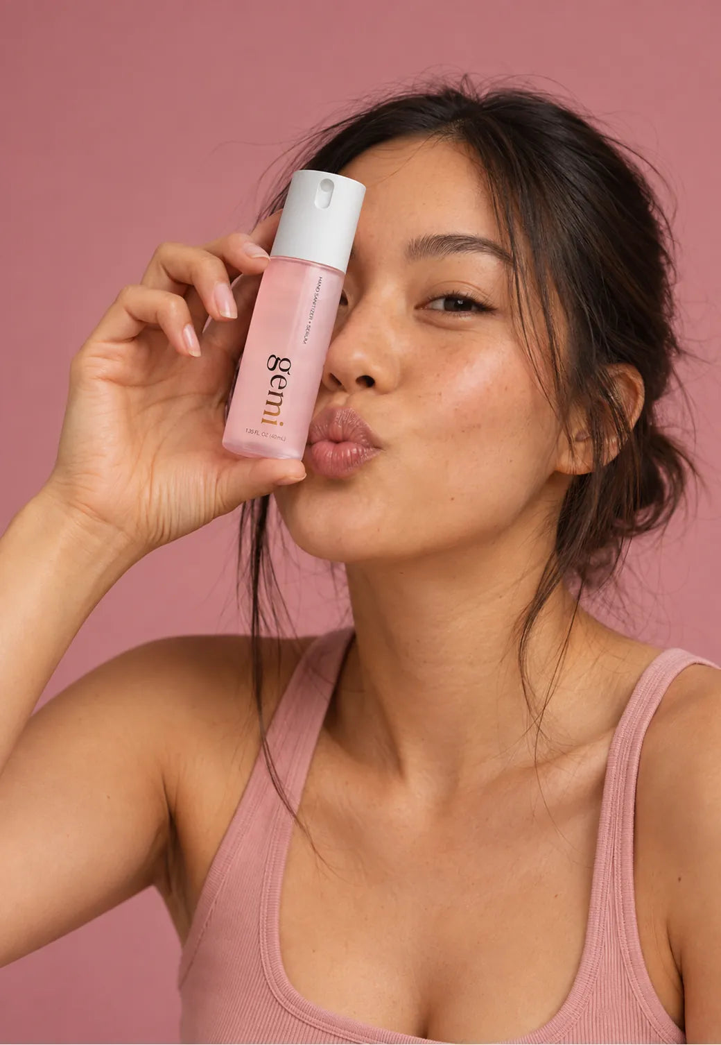 Woman holding a gemi bottle to her face